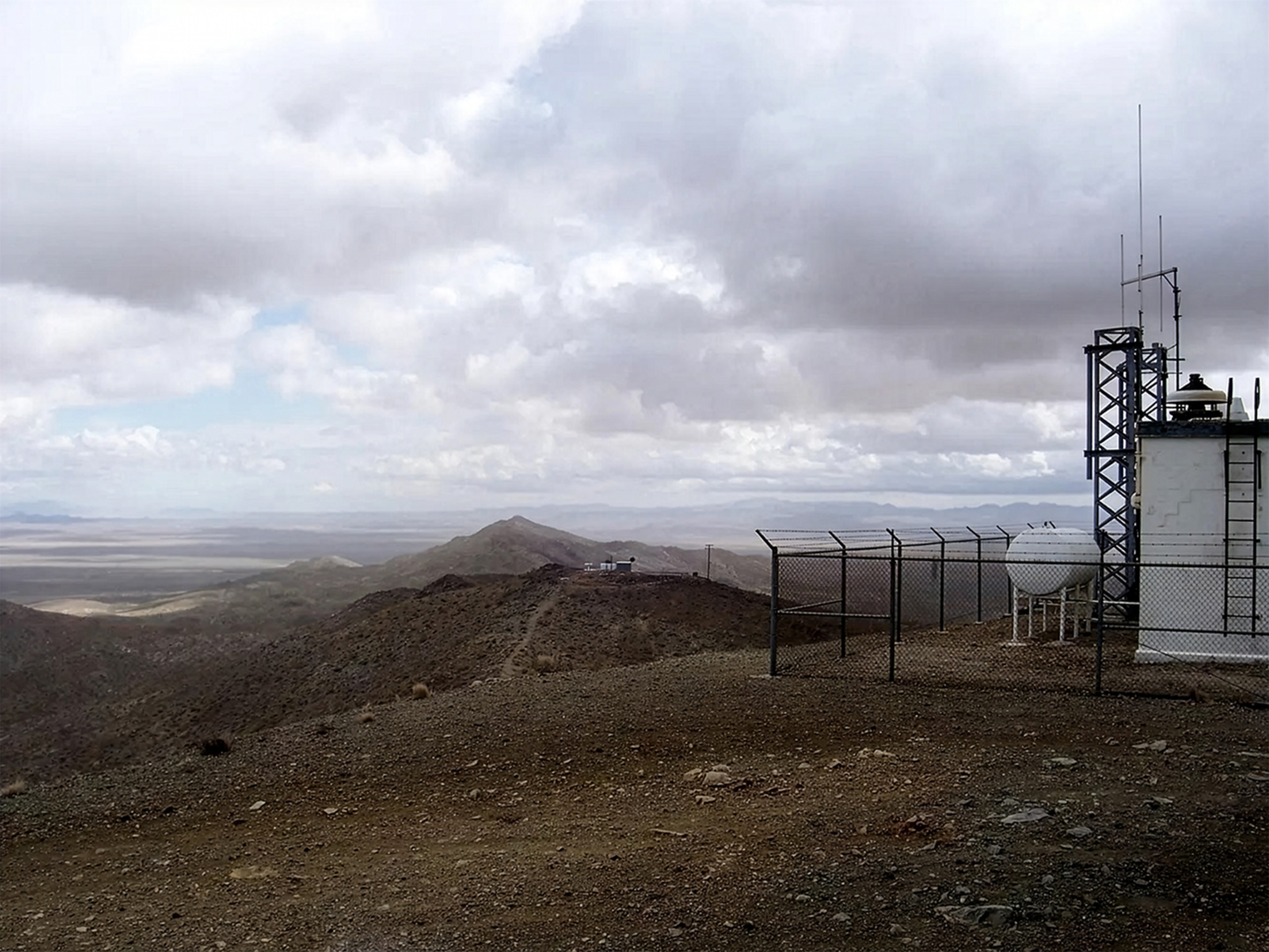 Shadow Mountain peak with structures and view over the valley