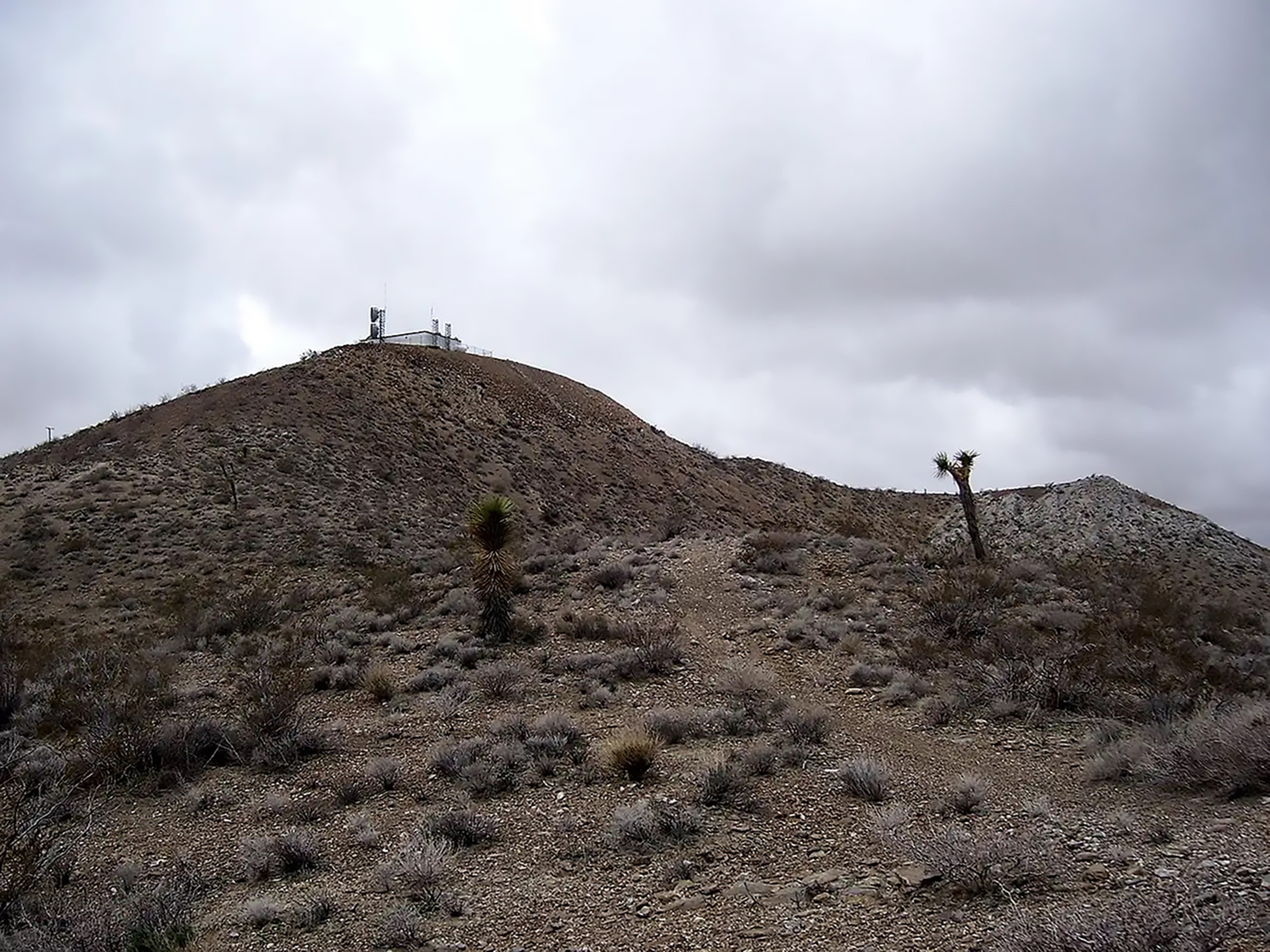 Shadow Mountain desert path toward summit structures